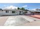 White brick ranch house with a spacious front yard and red brick driveway at 8151 W Clarendon Ave, Phoenix, AZ 85033