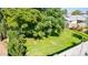 Large backyard with lush grass and mature trees at 8151 W Clarendon Ave, Phoenix, AZ 85033