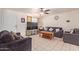 Living room with two dark gray sofas, a coffee table, and a large TV at 8151 W Clarendon Ave, Phoenix, AZ 85033
