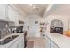 Kitchen with white cabinets, black appliances, and a view into the living room at 8151 W Clarendon Ave, Phoenix, AZ 85033