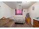 Serene bedroom with a double bed, wooden dresser, and wall art at 8151 W Clarendon Ave, Phoenix, AZ 85033
