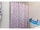 Simple bathroom with shower, toilet and a blue basket at 8151 W Clarendon Ave, Phoenix, AZ 85033