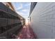 Side yard access with brick pathway between walls at 8151 W Clarendon Ave, Phoenix, AZ 85033
