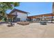 Outdoor patio area with seating, fire pit, and umbrellas at 10155 E Toledo Ave, Mesa, AZ 85212