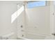 Bright bathroom with a bathtub and a window for natural light at 10155 E Toledo Ave, Mesa, AZ 85212