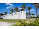 Community entrance sign with palm trees and landscaping at 10155 E Toledo Ave, Mesa, AZ 85212