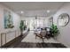 Open concept living room with dark floors, featuring a navy couch and access to a balcony at 7625 E Camelback Rd # A242, Scottsdale, AZ 85251