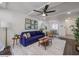 Modern living room with dark floors, navy couch, and a view into the dining area at 7625 E Camelback Rd # A242, Scottsdale, AZ 85251