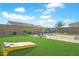 Backyard with artificial turf, patio, and cornhole at 17917 W Amberwood Dr, Goodyear, AZ 85338