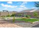 Landscaped backyard with artificial turf and cornhole game at 17917 W Amberwood Dr, Goodyear, AZ 85338