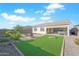 Large backyard with hot tub, patio, and artificial turf at 17917 W Amberwood Dr, Goodyear, AZ 85338