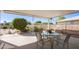 Covered patio with table and chairs, ideal for outdoor dining at 9409 W Glen Oaks N Cir, Sun City, AZ 85351