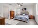 Spacious bedroom with a king-size bed and wood dresser at 23852 N 167Th Ln, Surprise, AZ 85387