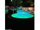 Night view of a kidney-shaped pool with green lighting at 23852 N 167Th Ln, Surprise, AZ 85387