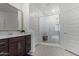 Modern bathroom with a large walk-in shower and double vanity at 23852 N 167Th Ln, Surprise, AZ 85387