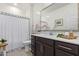 Clean bathroom with dark brown vanity, large mirror, and shower at 23852 N 167Th Ln, Surprise, AZ 85387