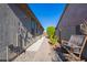 Landscaped walkway with a shower and rocking chair at 23852 N 167Th Ln, Surprise, AZ 85387