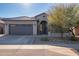 Modern home's exterior features a two-car garage and stone accents at 23852 N 167Th Ln, Surprise, AZ 85387