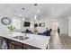 Modern kitchen island with white countertop and double sink, overlooking the living room at 23852 N 167Th Ln, Surprise, AZ 85387