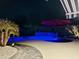 Night view of a kidney-shaped pool with blue lighting at 23852 N 167Th Ln, Surprise, AZ 85387
