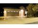 Attractive single-story home with a three-car garage at night at 23852 N 167Th Ln, Surprise, AZ 85387