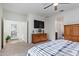 Bright bedroom with king-size bed, dresser, and access to the bathroom at 23852 N 167Th Ln, Surprise, AZ 85387