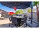 Outdoor patio furniture under an umbrella near a pool at 23852 N 167Th Ln, Surprise, AZ 85387