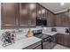 Modern kitchen with dark cabinets and white countertops at 23852 N 167Th Ln, Surprise, AZ 85387