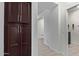 Hallway with dark brown storage cabinets and tile flooring at 23852 N 167Th Ln, Surprise, AZ 85387