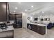 Open concept kitchen with island and stainless steel appliances at 23852 N 167Th Ln, Surprise, AZ 85387