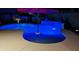 Night view of a kidney-shaped pool with blue lighting at 23852 N 167Th Ln, Surprise, AZ 85387