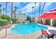 Community pool with lounge chairs and red umbrellas at 4812 N 73Rd St, Scottsdale, AZ 85251