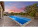 Inviting rectangular pool with a water feature and sunset view at 16746 W La Reata Ave, Goodyear, AZ 85395