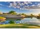 Serene lake with community entrance sign; peaceful ambiance at 17917 W Amberwood Dr, Goodyear, AZ 85338