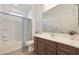 Clean bathroom with a shower/tub combo, wood vanity, and tile floor at 17917 W Amberwood Dr, Goodyear, AZ 85338