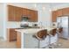 Kitchen island with seating and white countertops at 17917 W Amberwood Dr, Goodyear, AZ 85338