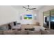 Gathering room with sectional sofa, backyard view, and ceiling fan at 17917 W Amberwood Dr, Goodyear, AZ 85338