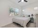 Bright bedroom with a queen bed, window shutters, and ceiling fan at 17917 W Amberwood Dr, Goodyear, AZ 85338