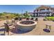 Relaxing fire pit area with seating and community clubhouse in background at 17917 W Amberwood Dr, Goodyear, AZ 85338