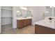 Double vanity bathroom with a large mirror and walk-in closet at 17917 W Amberwood Dr, Goodyear, AZ 85338