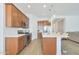 Open kitchen with island and stainless steel appliances at 17917 W Amberwood Dr, Goodyear, AZ 85338
