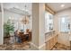 Formal dining room with a large chandelier and stone flooring at 7801 N Sherri Ln, Paradise Valley, AZ 85253