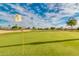 Golf course putting green with flag at 3582 N 160Th Ave, Goodyear, AZ 85395