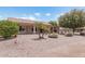 Spacious backyard with gravel landscaping, mature trees, and a covered patio at 3582 N 160Th Ave, Goodyear, AZ 85395
