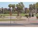 Golf course view with a golf cart and modern apartment buildings in the background at 3582 N 160Th Ave, Goodyear, AZ 85395