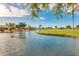 Serene waterfront property with palm trees and lush landscaping at 3582 N 160Th Ave, Goodyear, AZ 85395
