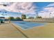 Well-maintained tennis court with surrounding landscaping at 3582 N 160Th Ave, Goodyear, AZ 85395