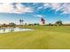 Golf course with a pond and residential homes in the background at 3582 N 160Th Ave, Goodyear, AZ 85395