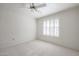 Bedroom with carpet, window shutters, and ceiling fan at 14908 W Alpaca Dr, Sun City West, AZ 85375