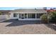 Large backyard with gravel and screened patio at 14908 W Alpaca Dr, Sun City West, AZ 85375